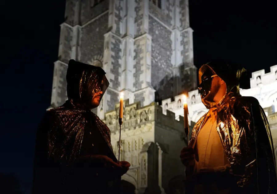 Two masked figures meeting in secret at night